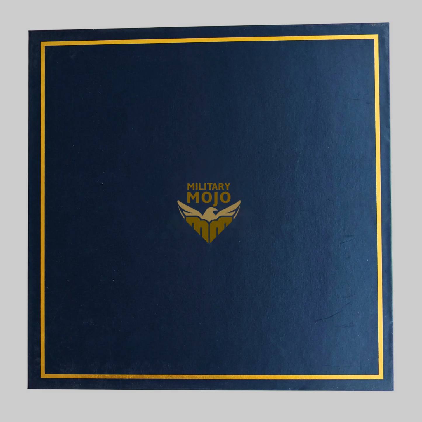 Blue folder with gold border and 'Military Mojo' logo on a white background