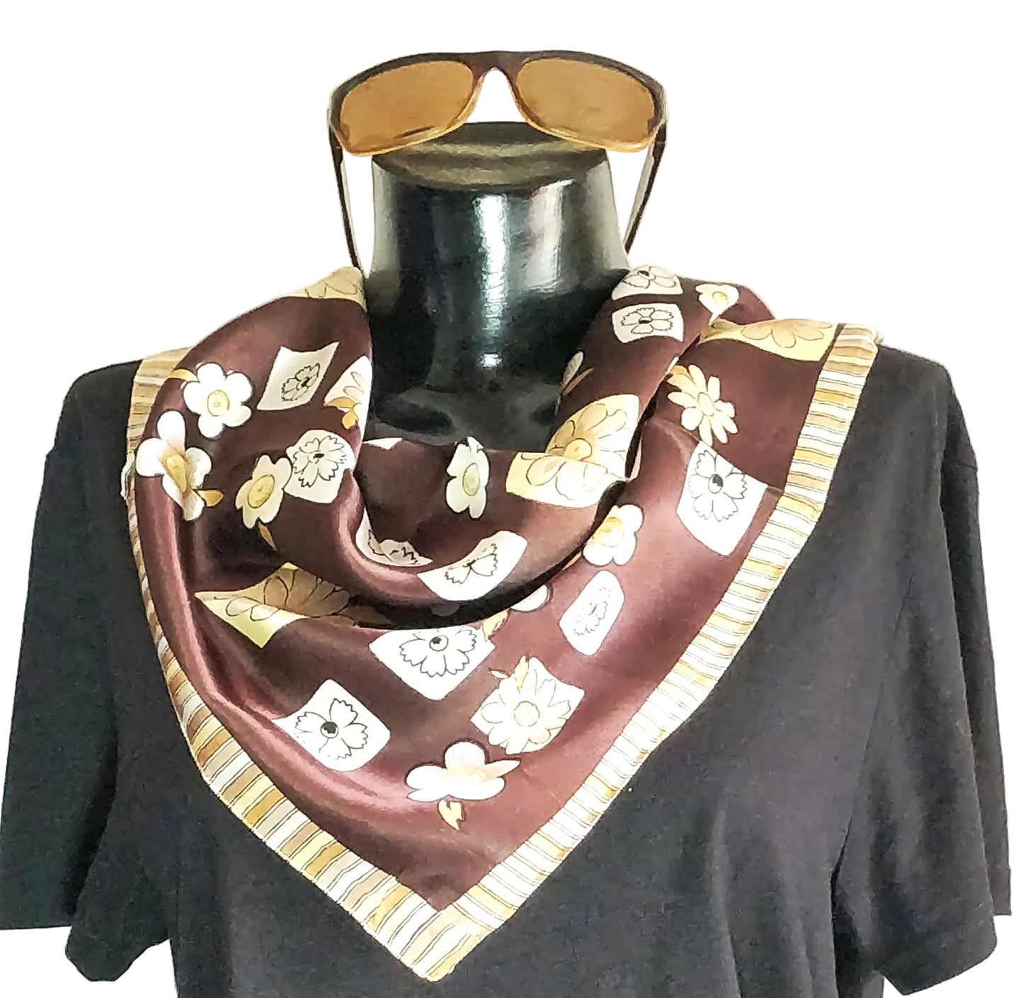 A dark brown printed satin silk neckwear and bandana displayed on a mannequin, featuring floral and geometric patterns.