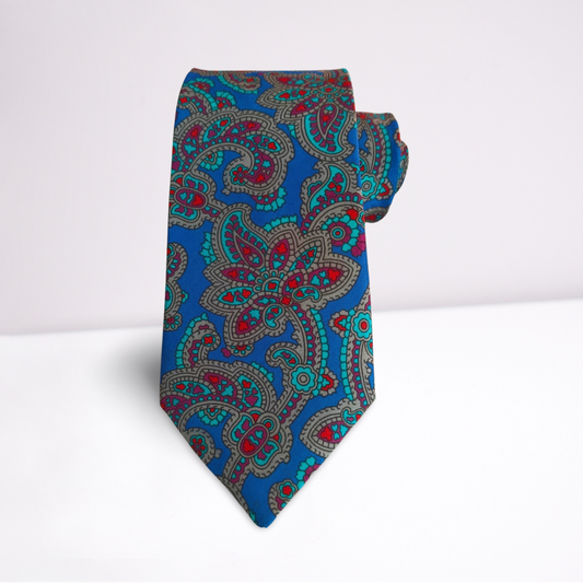 Blue paisley patterned tie on a white background