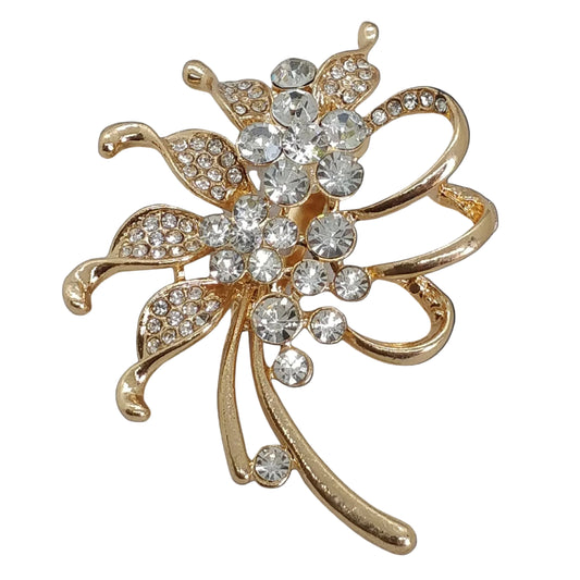 A gold-colored brooch with a floral design, adorned with clear crystals.