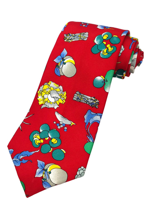 A red necktie with a jacquard weave pattern featuring colorful fruit and insect illustrations.
