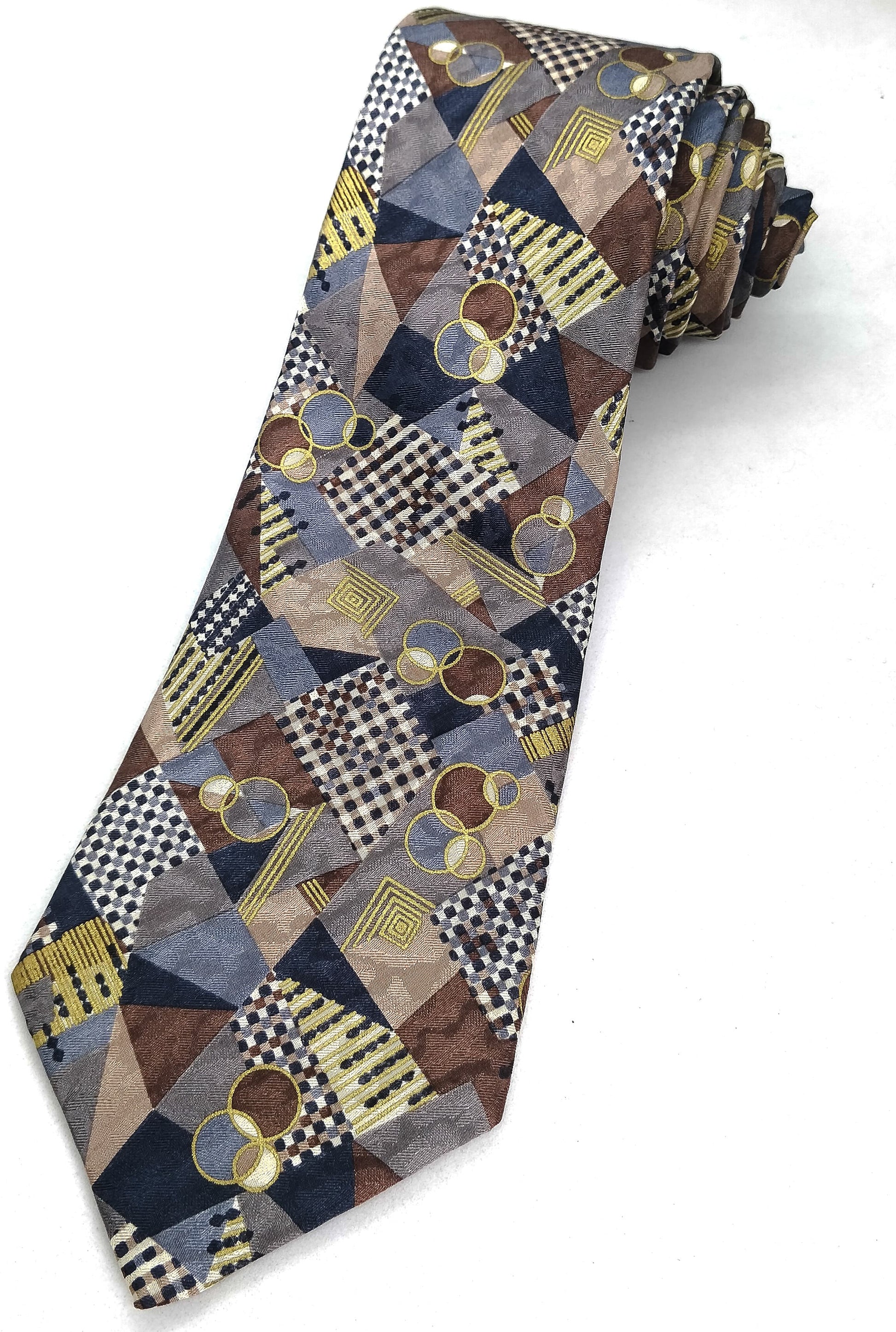 A multicolored jacquard silk necktie with a geometric pattern, primarily in shades of blue, brown, and beige.
